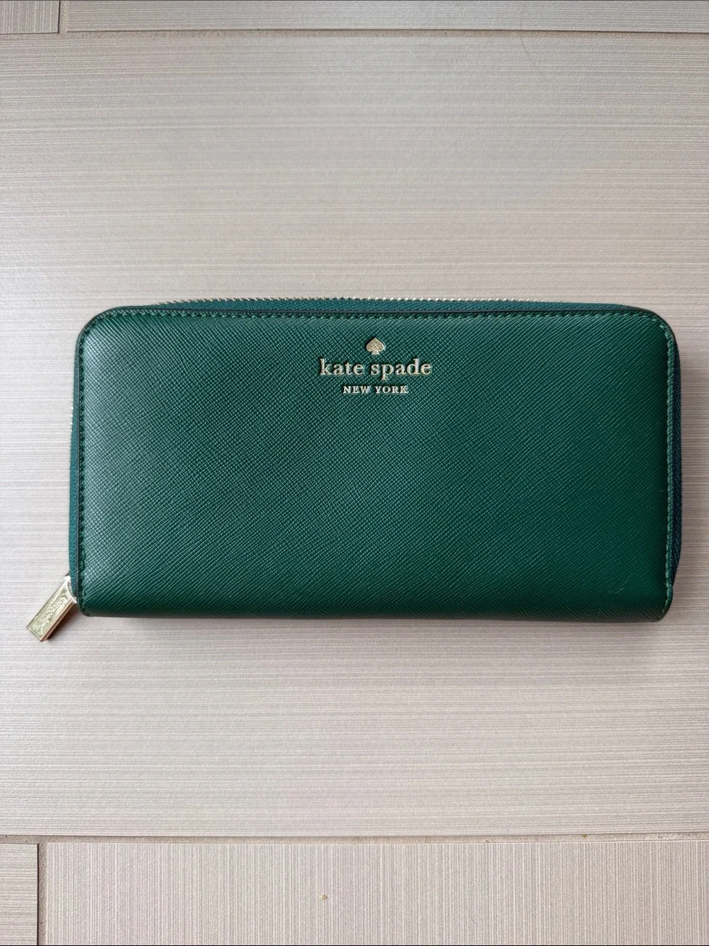 kate spade green zip-around saffiano wallet with gold logo